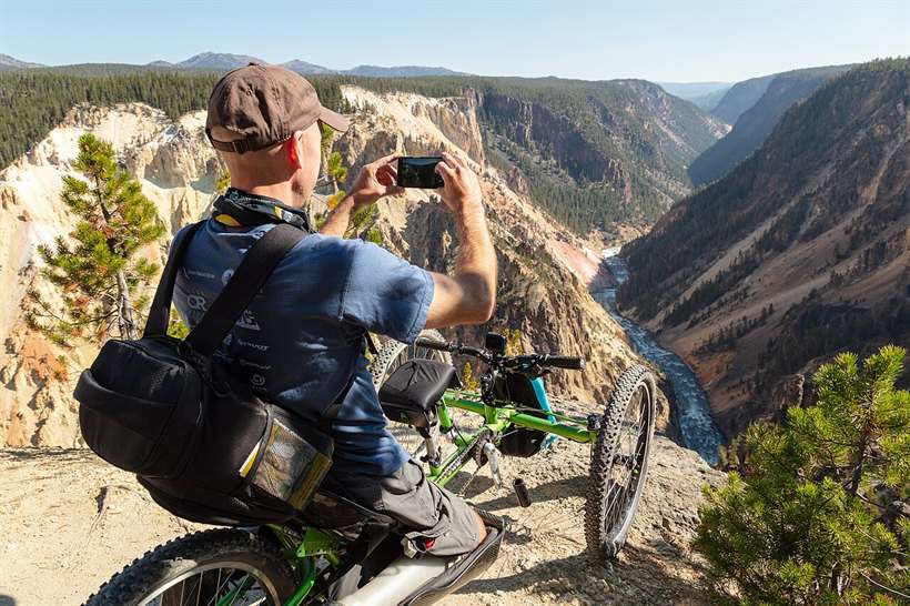 A visitor using an all-terrain wheelchair takes in a canyon overlook