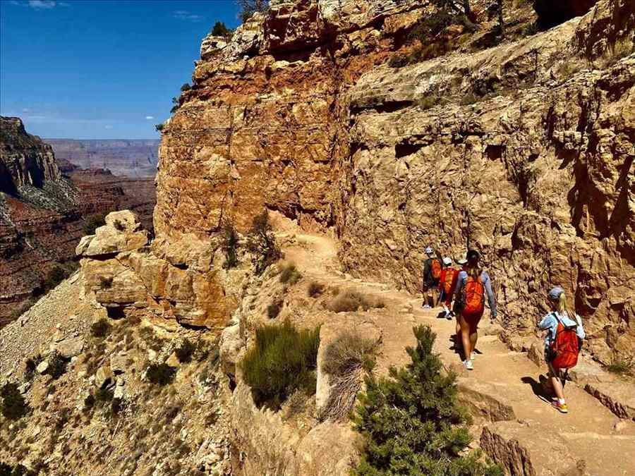 A group hiking a canyon trail