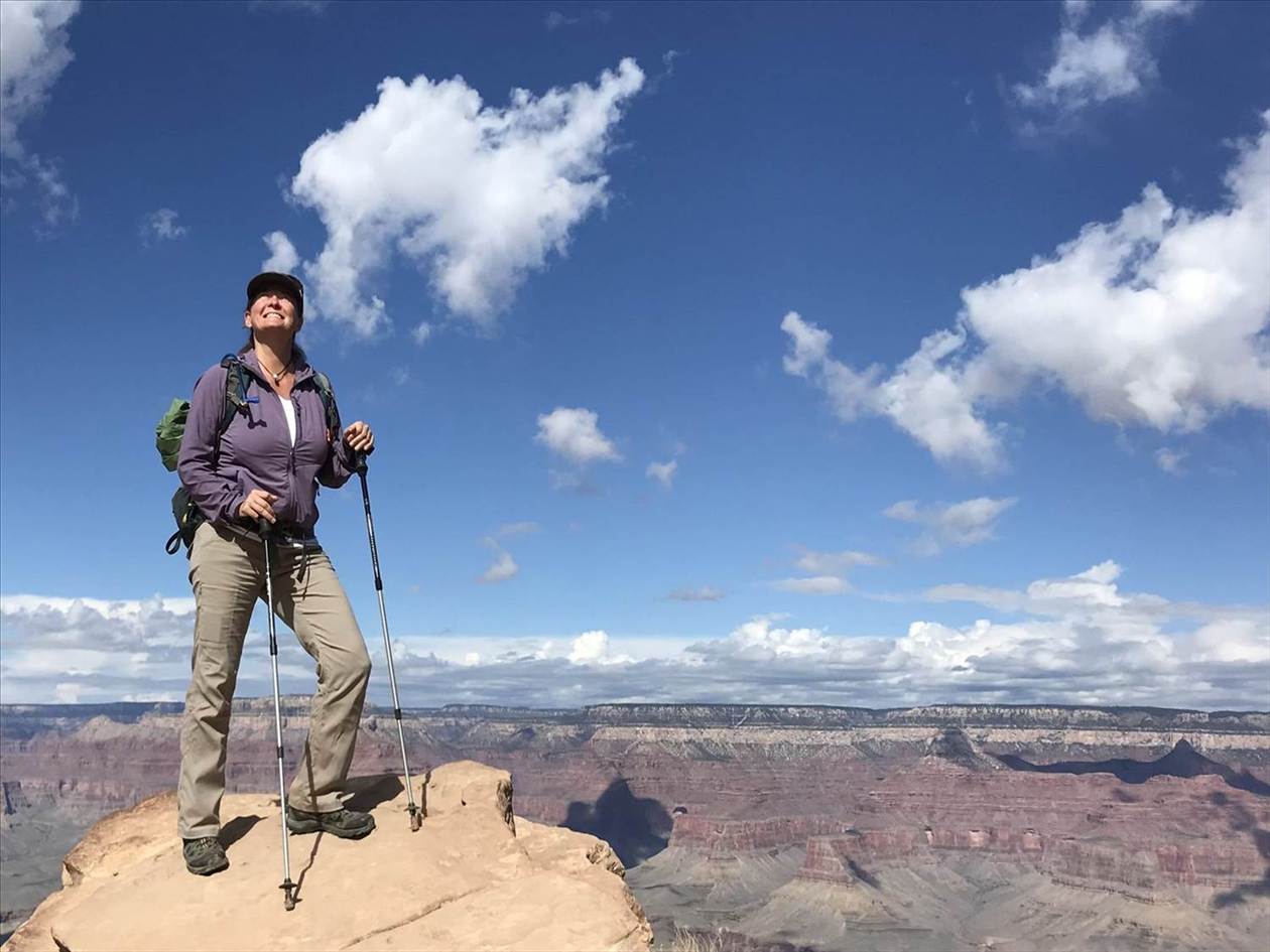 Hiker with trekking poles overlooking the canyon