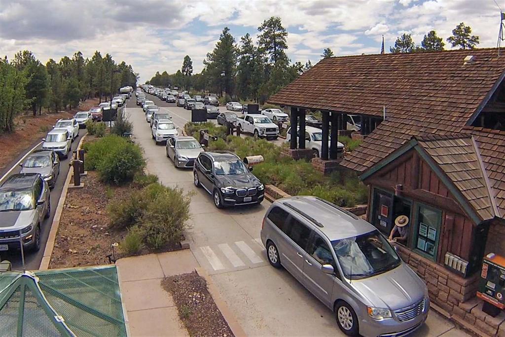 Cars lined up at the Grand Canyon National Park entrance station where rangers collect entrance fees