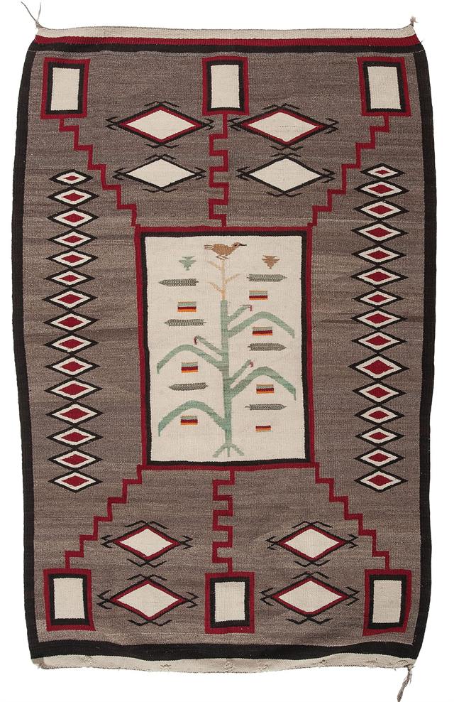 A historic Navajo weaving with a cornstalk and bird pictorial design, early 20th century