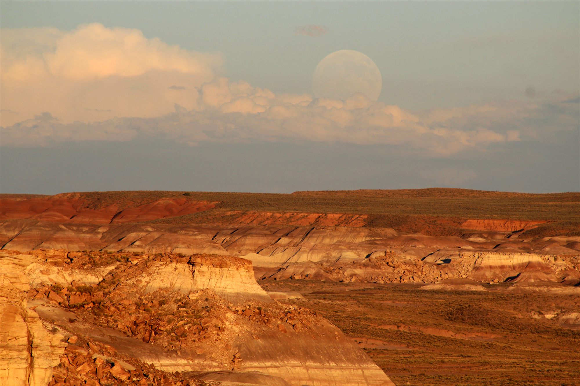 Sunset light over the striped badlands of the Painted Desert, Arizona, with a rising moon (National Park Service photo)